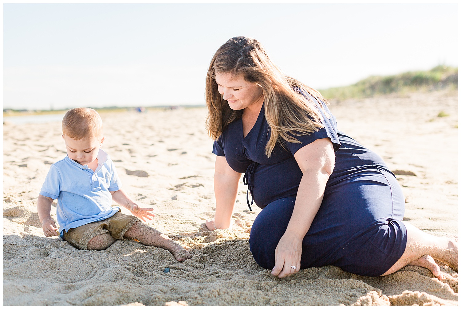 mother and son playing in sand on cape cod beach