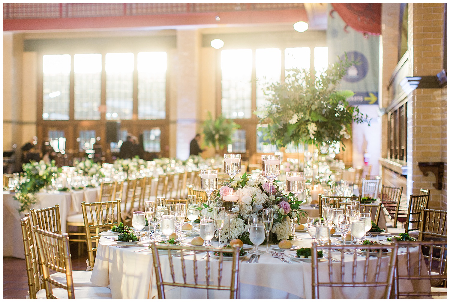 elegant white and green floral wedding table setting in railroad terminal