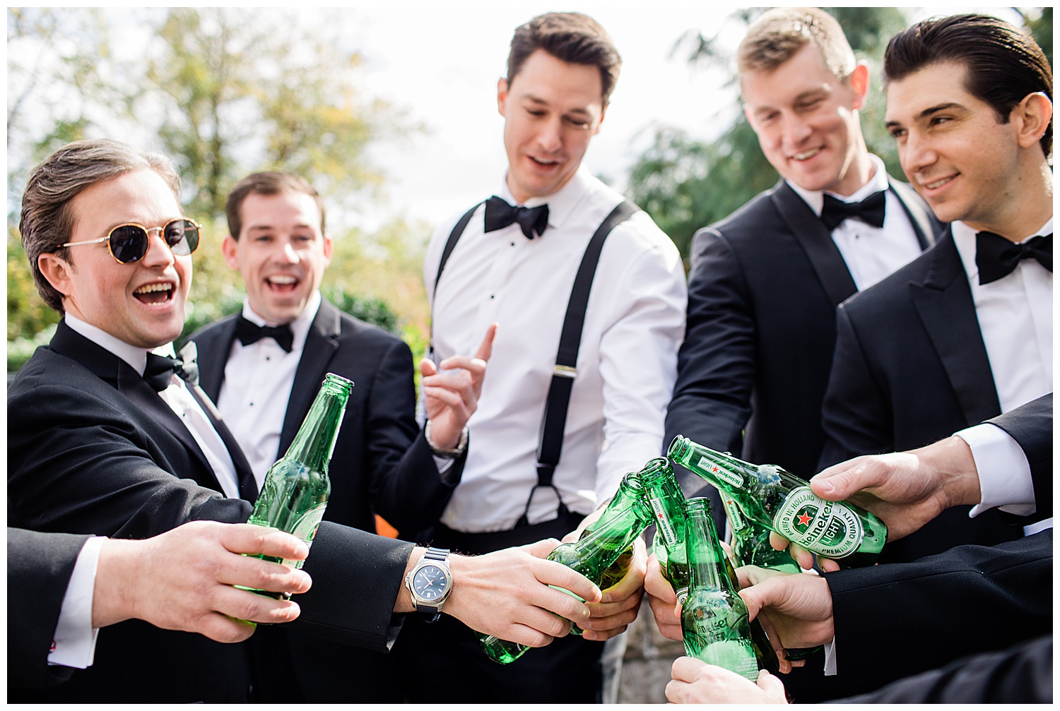 groomsmen cheers with a drink before the wedding