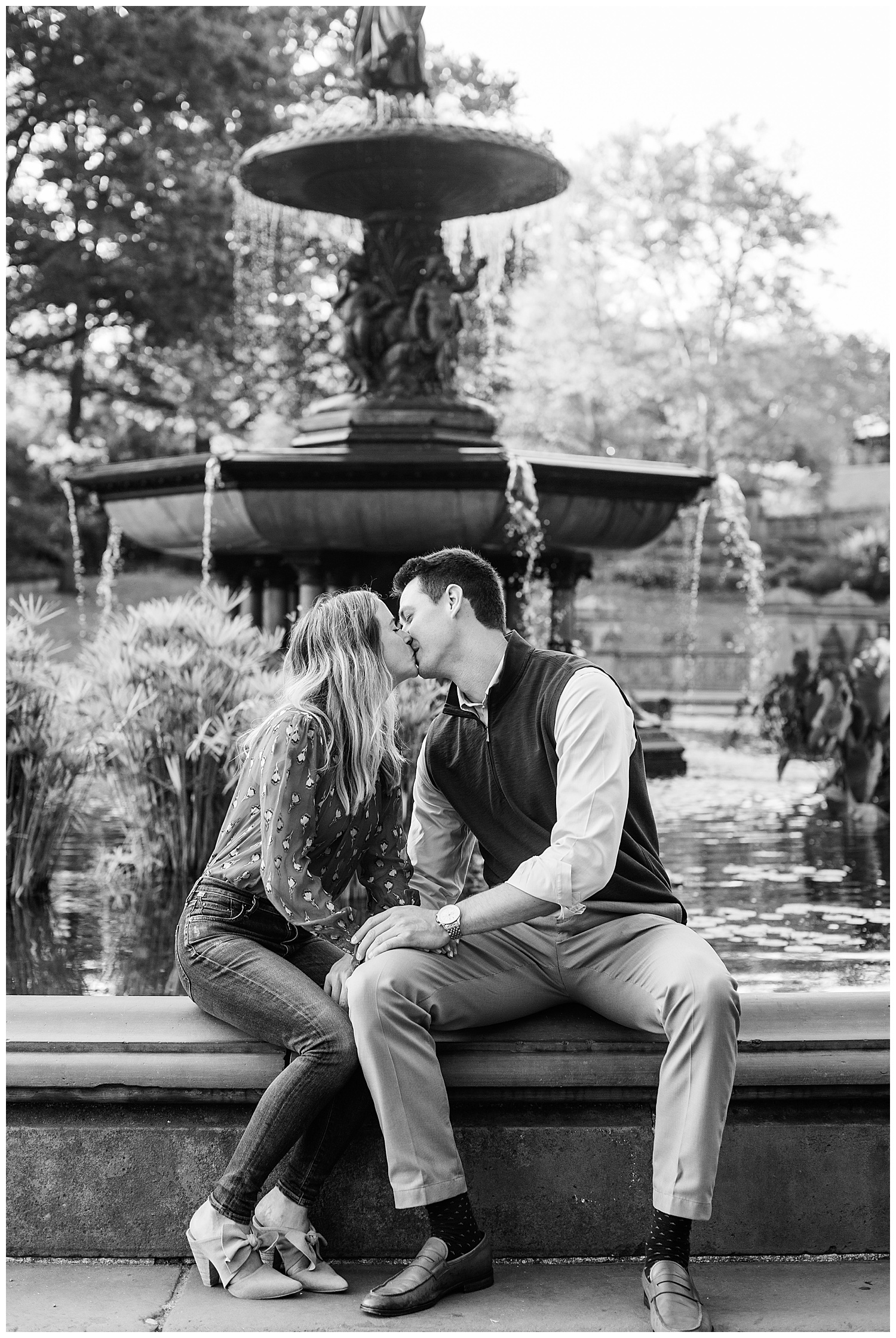 Couple kiss in front of fountain in Central Park