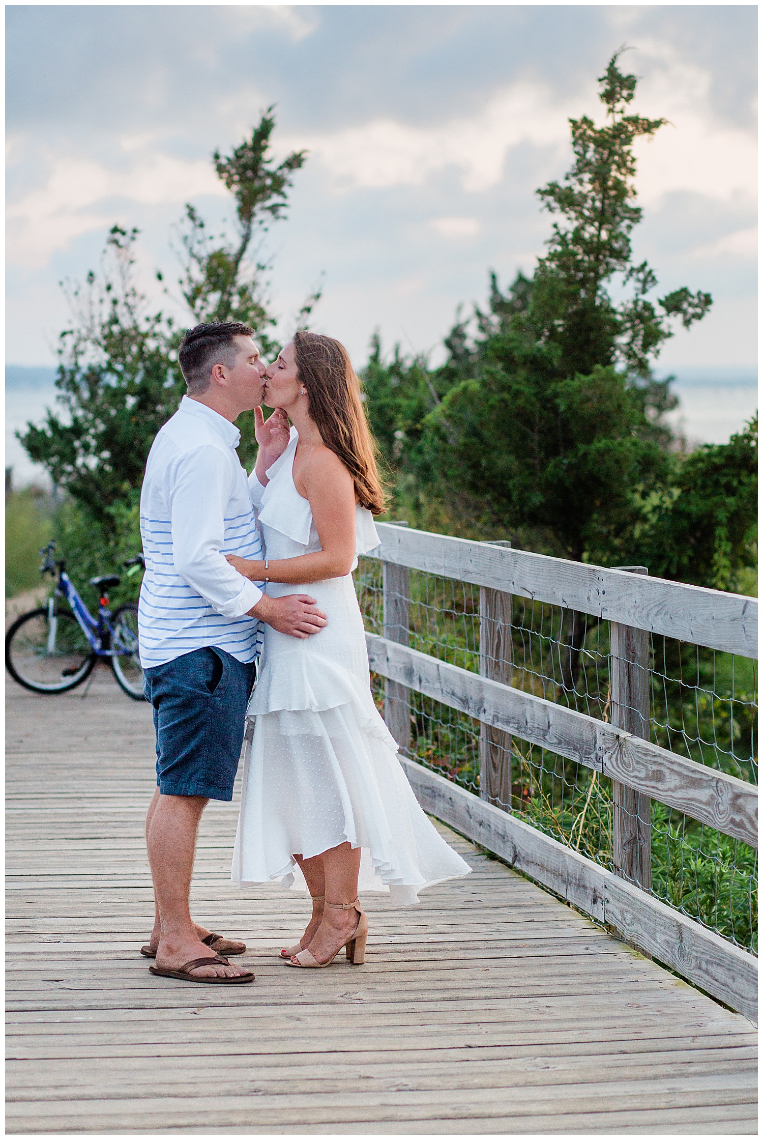 Couple kiss on boarded beach path