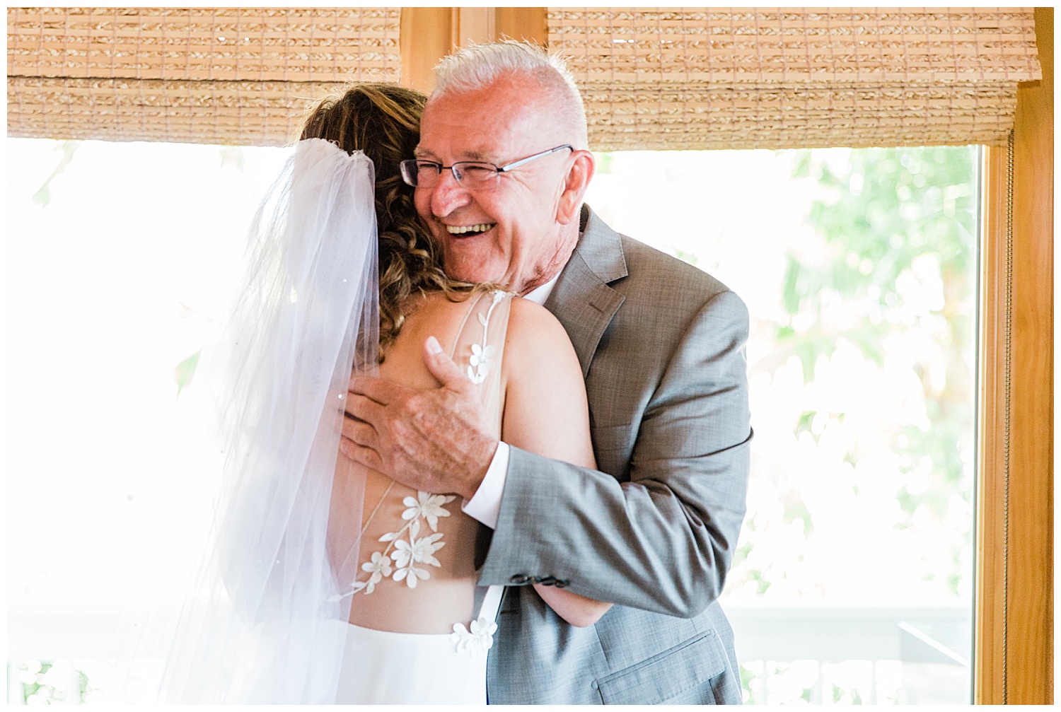 bride wiping tears after seeing father on her wedding day