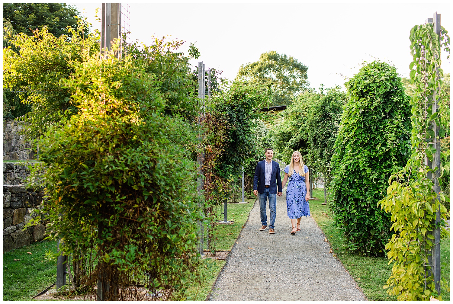 Couple walk down arboretum path surrounded by greenery